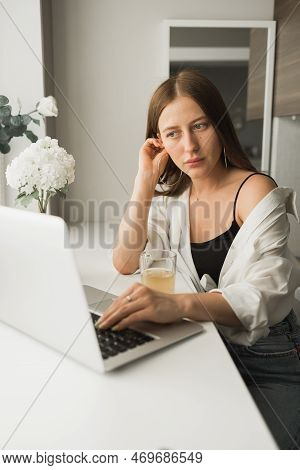 Close Up Of Young Pretty Woman Drinking Tea While Break After Typing And Browsing Online On Laptop W