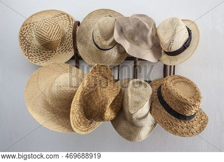 Rack Cluttered With Hats Made From Vegetable Fibers. Country Style