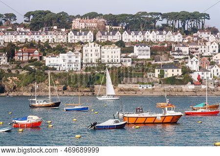 Cornwall, Uk - October 12, 2008. Boats Moored In Fowey Harbour With Houses On The Seafront. Fowey, C