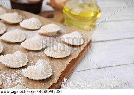 Raw Dumplings (varenyky) With Tasty Filling On White Wooden Table, Closeup. Space For Text