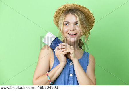 Travel Ideas. Dreaming Winsome Llovely Smiling Young Girl In Straw Hat And Blue Dress Holding Passpo