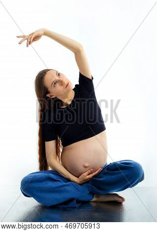 Pleasant Pregnant Woman Posing In Profile And Trying Yoga Young Happy Expectant Relaxing, Thinking A