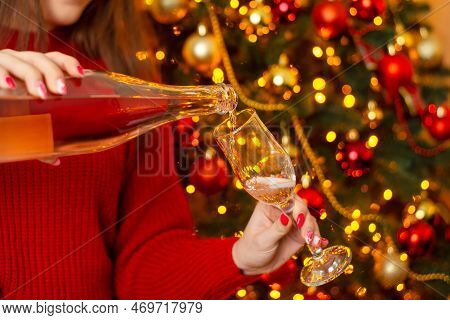 Pouring Champaigne To The Glass. Young Wooman Pouring Champigne From Bottle To Glasss In Decorated C