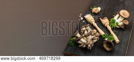 Delicious Organic Oyster Mushrooms With Spices And Fresh Parsley On Wooden Cutting Board