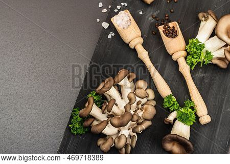 Delicious Organic Oyster Mushrooms With Spices And Fresh Parsley On Wooden Cutting Board