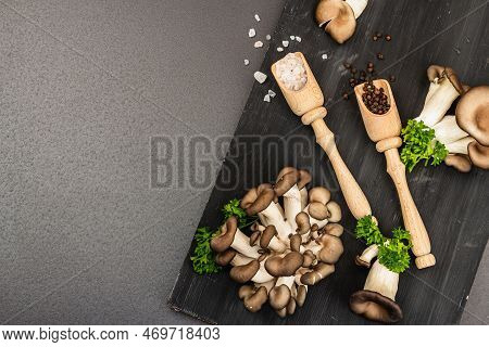 Delicious Organic Oyster Mushrooms With Spices And Fresh Parsley On Wooden Cutting Board