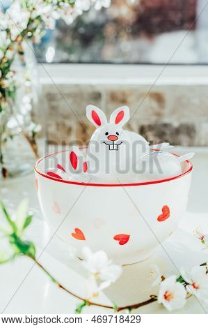 Funny Easter Eggs Containers With Bunny Ears Filled With Candy And Chocolate In Bowl On White Kitche