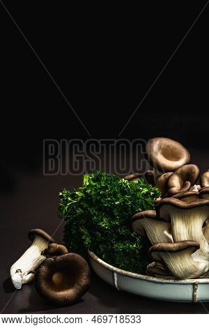 Delicious Organic Oyster Mushrooms With Fresh Parsley. Source Of Beta Glucan, Black Stone Background
