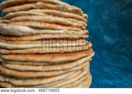 Flatbread Lavash, Chapati, Naan, Heap Of Tortilla On A Blue Background Homemade Flatbread Stacked.