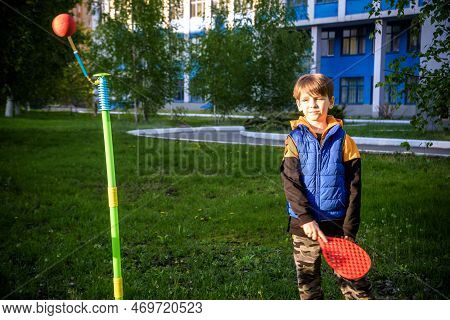 Happy Boy Is Playing Tetherball Swing Ball Game In Summer Camping. Happy Leisure Healthy Active Time