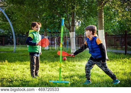 Two Friends Are Playing Tetherball Swing Ball Game In Summer Camping. Two Boy Brother Happy Leisure