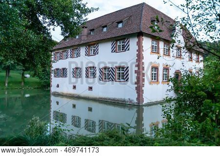 Moated Castle With Moat In Inzlingen By Day