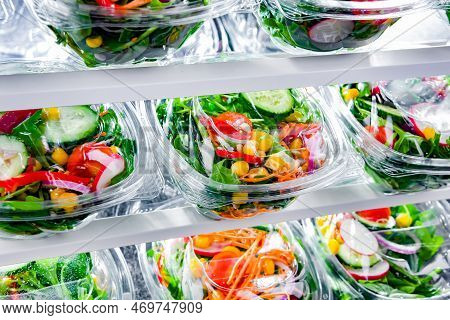 Boxes With Pre-packaged Vegetable Salads In A Commercial Fridge
