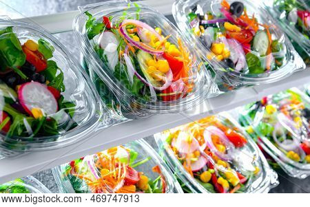 Boxes With Pre-packaged Vegetable Salads In A Commercial Fridge