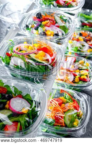 Boxes With Pre-packaged Vegetable Salads In A Commercial Fridge