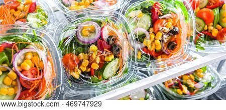 Boxes With Pre-packaged Vegetable Salads In A Commercial Fridge