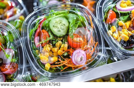Boxes With Pre-packaged Vegetable Salads In A Commercial Fridge
