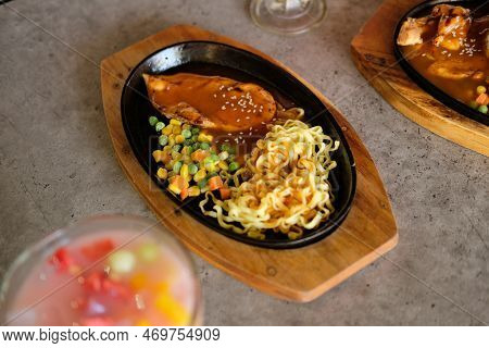 Close-up Of A Bowl Of Soba Noodles With Sliced Roast Beef Steak. Asian Cuisine