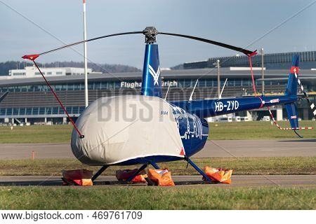 Zurich, Switzerland, January 19, 2023 Robinson R44 Helicopter Is Parking At The International Airpor