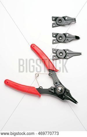 Sideways Snap Ring Pliers Set On A Light Gray Background In Vertical Composition