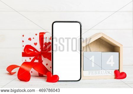 Mobile Phone With Blank Screen On Colored Background With Hearts, Calendar And Gift Box, Valentine D