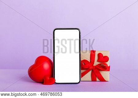 Mobile Phone With Blank Screen On Colored Background With Hearts, Calendar And Gift Box, Valentine D