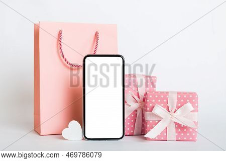 Mobile Phone With Blank Screen On Colored Background With Hearts, Calendar And Gift Box, Valentine D