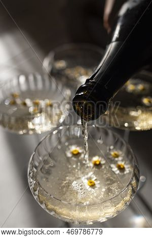 Champagne Pourig Into Glasses On A Light Table Surface Reflecting Soft Sunshine Rayson. Sparkling Wi