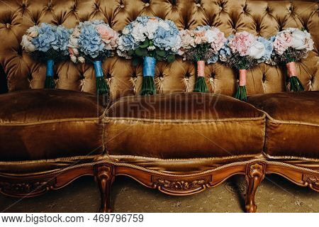 Colorful Bouquets On The Sofa. Wedding Bouquet Of Blue And White Colors On A Yellow Sofa