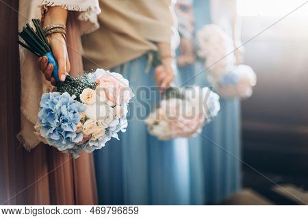 Bridesmaids At Wedding With Bouquets In Hands. Girl In Colored Dresses For Wedding.