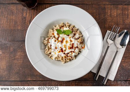 Kayseri Ravioli Or Kayseri Mantisi On A White Plate On Wooden Table