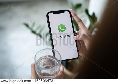 Chiang Mai, Thailand - Mar 30 2022 : Man Holding A Iphone And Open Appstore Searching Social Interne