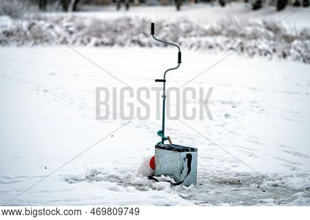 Fishing Equipment For Winter Ice Fishing On The Background Of A Frozen River. Ice Fishing.