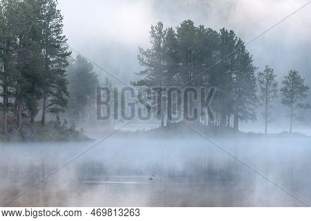 A Beautiful Early Morning Mist Hovering Over Stockade Lake In The Black Hills Of South Dakota With A