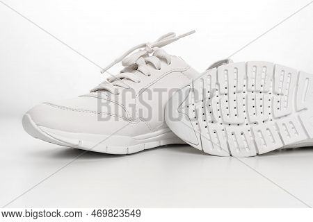 Leather Sneakers With Lacing And Perforated Sole On A White Background.