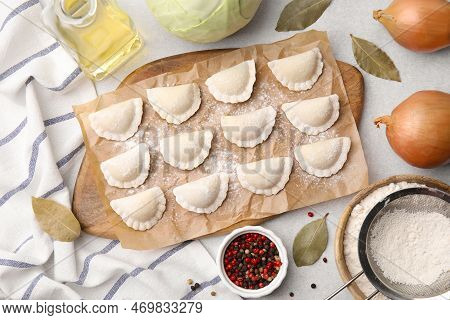 Raw Dumplings (varenyky) With Tasty Filling And Ingredients On Light Grey Table, Flat Lay