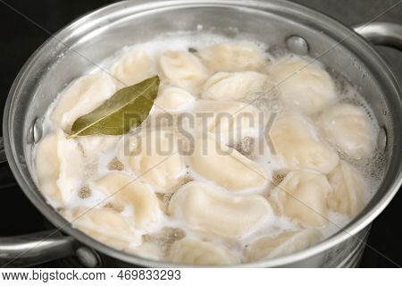 Cooking Dumplings (varenyky) With Tasty Filling And Bay Leaf In Pot, Closeup