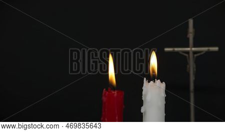 Banner Size Image Of Two Burning Candles And Christian Cross Against A Black Background With Free Co