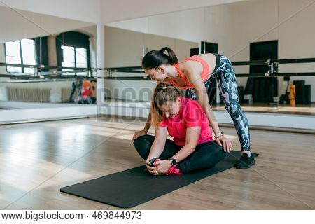 Fitness Trainer And Mentee Over Gym Room Background. Sport And Healthy Active Lifestyle Concept. Ind