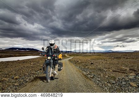 One Motorbiker Man Driving On A Gravel Road In Kaldidalur Desert. Motorcycle Adventure In Iceland.