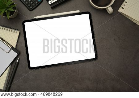 Top View Of Digital Tablet With Blank Screen, Cup Of Coffee And Notepad On Black Slate Texture Backg