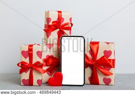 Mobile Phone With Blank Screen On Colored Background With Hearts, Calendar And Gift Box, Valentine D