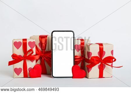 Mobile Phone With Blank Screen On Colored Background With Hearts, Calendar And Gift Box, Valentine D