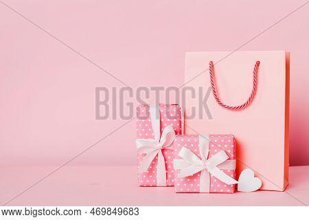Shopping Bag With Gift Box On Colored Background Perspecrive View. Space For Text Holiday Concept.
