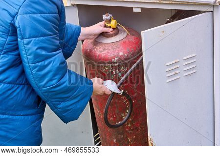 Consumer Places Filled Gas Cylinder Into Cabinet.