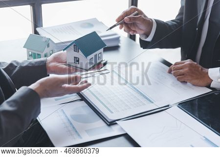Business Property,real Estate And Investment Concepts. Real Estate Agent Present Terms Of The Home P