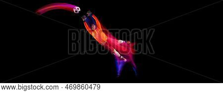 Sportive Energetic Man, Soccer Football Goalkeeper In Action, Motion Over Dark Background With Mixed