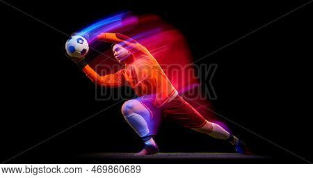 Sportive Energetic Man, Soccer Football Goalkeeper In Action, Motion Over Dark Background With Mixed