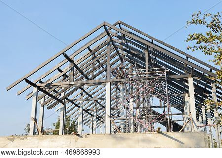 Steel Roof Structure. Detail Of Building Structure With Black Steel Roof Trusses For New Building In