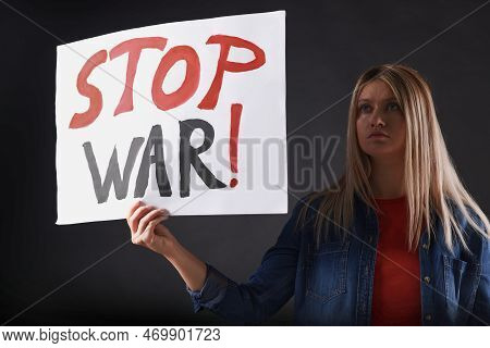 Sad Woman Holding Poster With Words Stop War On Black Background